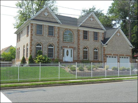Brick house with white fence
