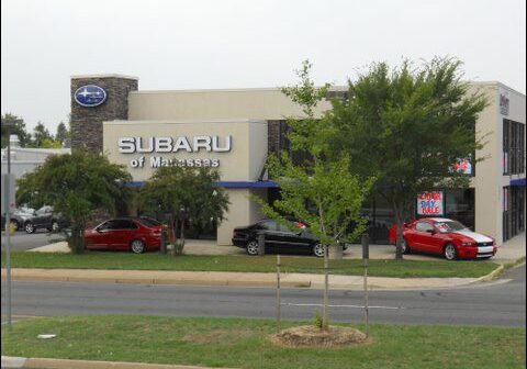 Subaru dealership exterior with parked cars