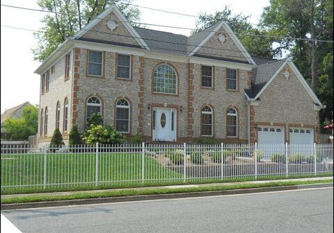 Brick house with white fence